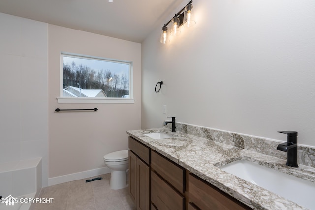 bathroom featuring tile patterned floors, vanity, and toilet