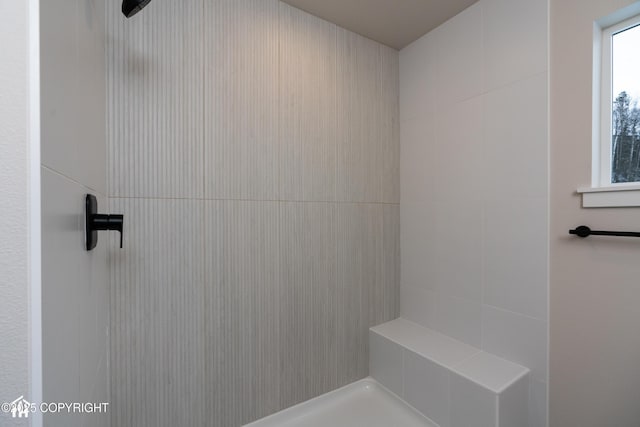 bathroom with a tile shower