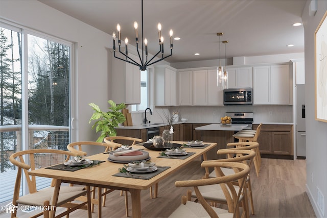 dining space featuring sink and light hardwood / wood-style floors