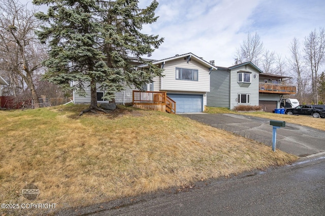 view of front of house featuring an attached garage, a front yard, and aphalt driveway