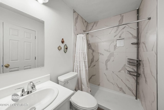 bathroom with toilet, vanity, and a stall shower