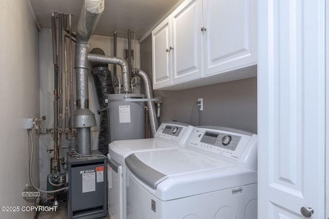 laundry area with washing machine and clothes dryer, cabinet space, and electric water heater