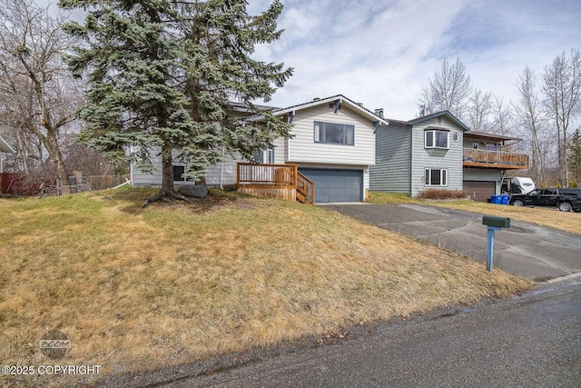 7025 Fredricks Dr, Anchorage, AK 99504 - view of front facade with a garage, asphalt driveway, and a front lawn