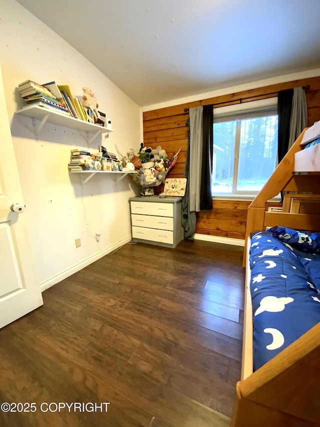 bedroom with lofted ceiling and dark hardwood / wood-style floors