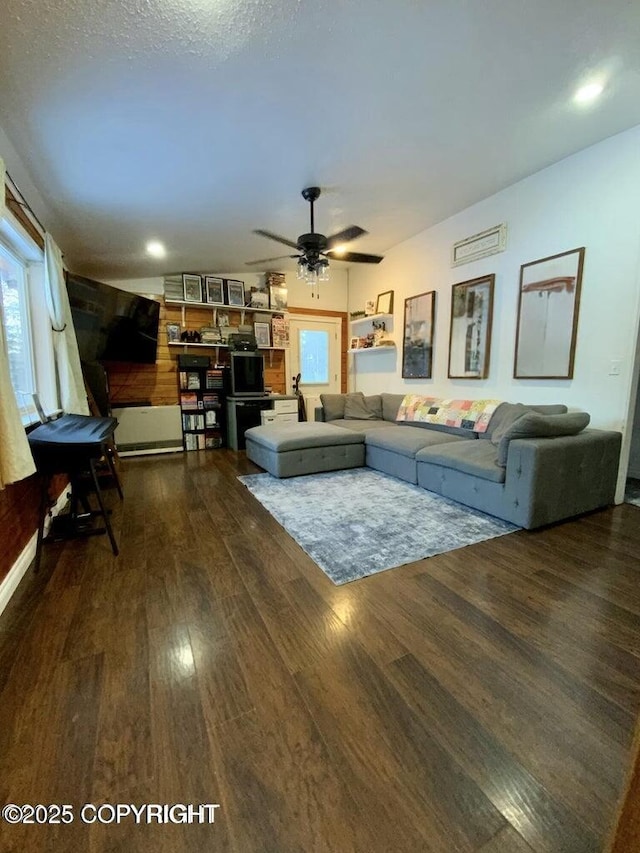 unfurnished living room with dark wood-type flooring and ceiling fan