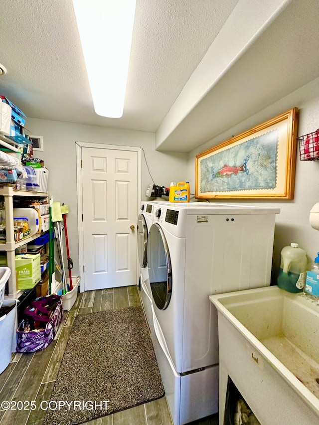 laundry area with washer and clothes dryer, sink, and a textured ceiling