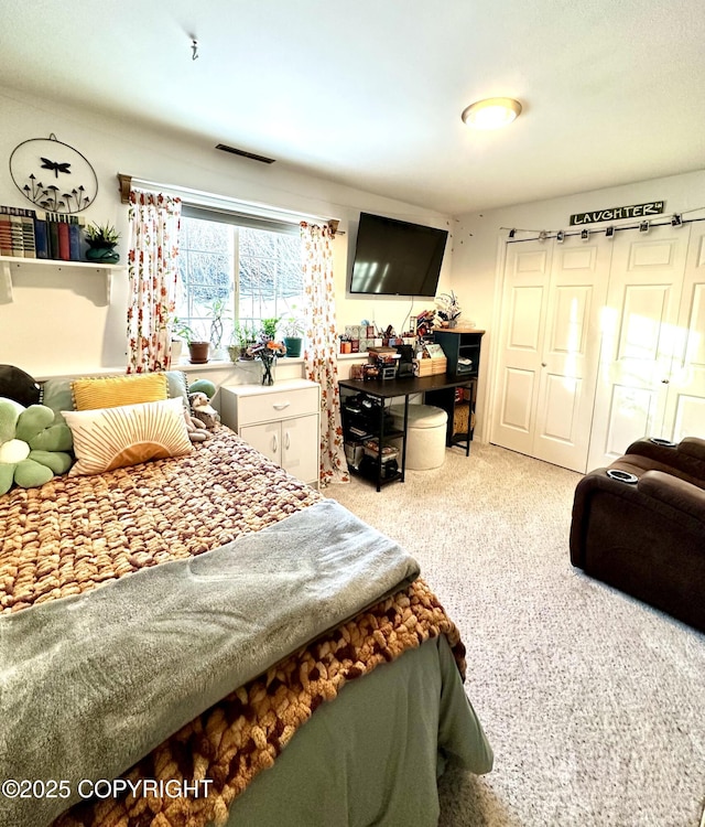 carpeted bedroom with a closet