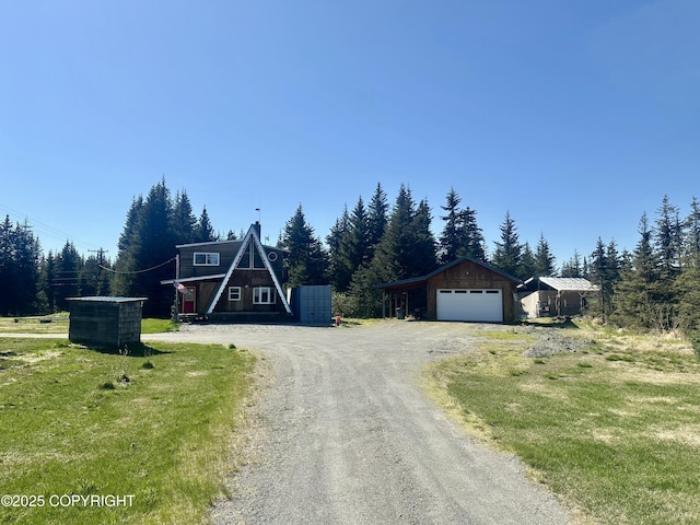 1060 Jeffery Ave, Homer, AK 99603 - a-frame home with a garage, an outbuilding, and driveway