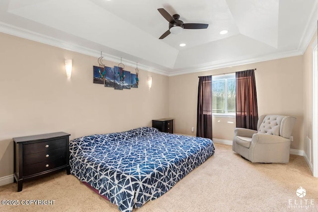 bedroom featuring a raised ceiling, ornamental molding, carpet floors, and ceiling fan