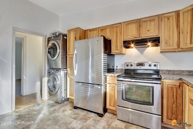 kitchen featuring under cabinet range hood, appliances with stainless steel finishes, light countertops, and stacked washer and clothes dryer