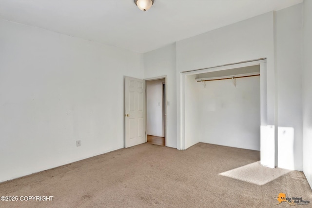 unfurnished bedroom featuring carpet floors and a closet