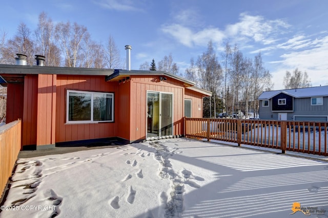 rear view of property featuring fence and a wooden deck