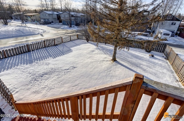 snow covered deck with a residential view