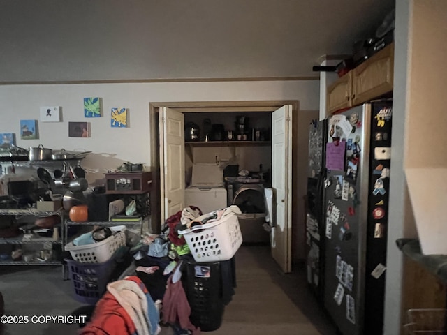 interior space featuring ornamental molding and stainless steel fridge with ice dispenser