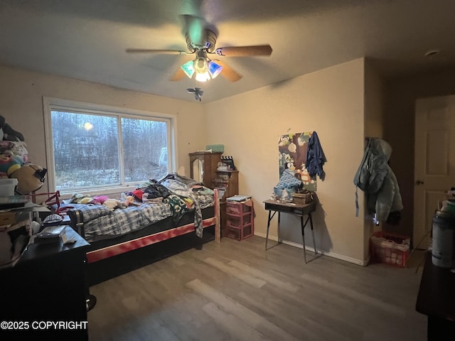 bedroom featuring hardwood / wood-style floors and ceiling fan