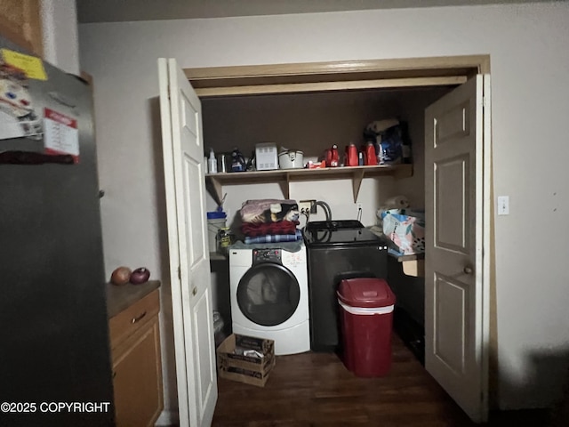 laundry area featuring dark hardwood / wood-style flooring and washer / dryer