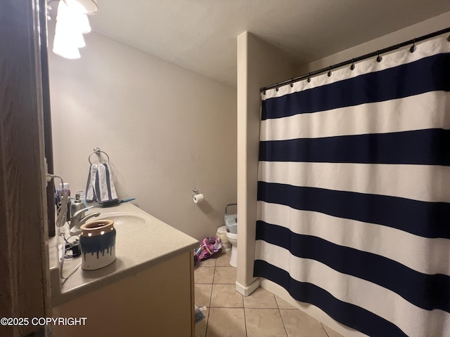 bathroom featuring vanity, tile patterned floors, and toilet