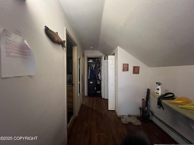 hallway featuring dark wood-type flooring, vaulted ceiling, and baseboard heating