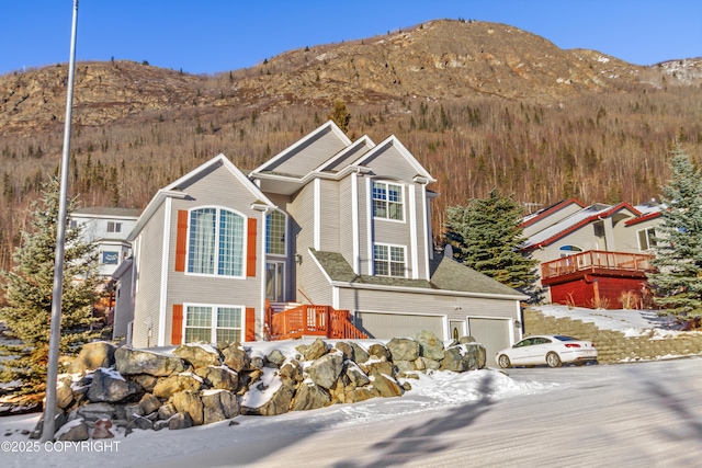 view of front of property with a mountain view and a garage