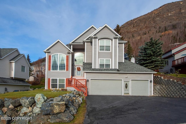 view of front of home with a mountain view and a garage