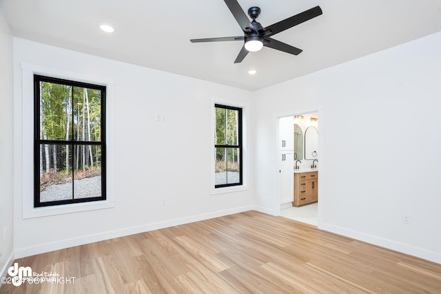 empty room featuring ceiling fan and light hardwood / wood-style flooring