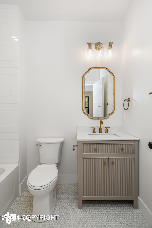 bathroom with vanity, tile patterned floors, and toilet