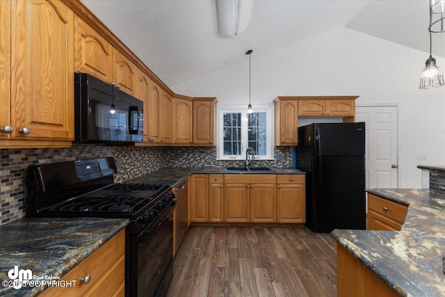 kitchen featuring pendant lighting, sink, dark stone countertops, dark hardwood / wood-style floors, and black appliances