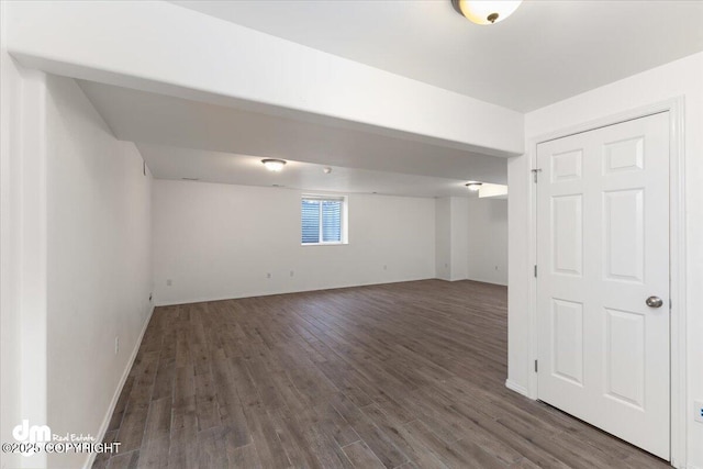 basement with dark hardwood / wood-style flooring