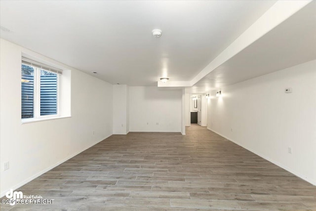 basement with light hardwood / wood-style floors