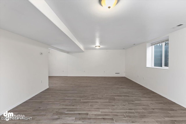 basement with hardwood / wood-style floors