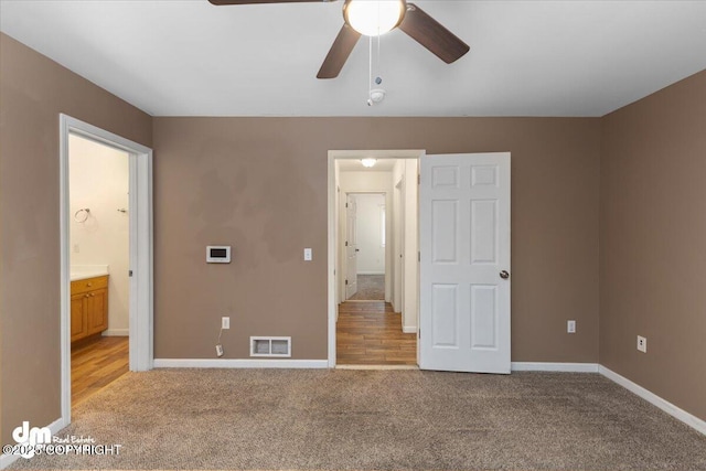 unfurnished bedroom with light colored carpet and ceiling fan