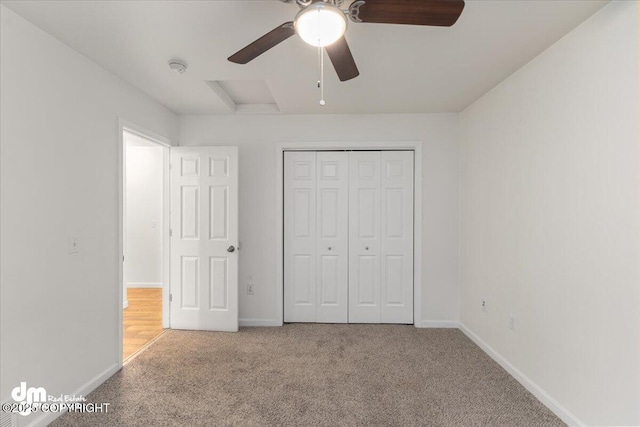 unfurnished bedroom with light carpet, ceiling fan, and a closet