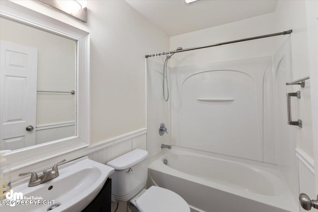 full bathroom featuring sink, shower / bathing tub combination, and toilet