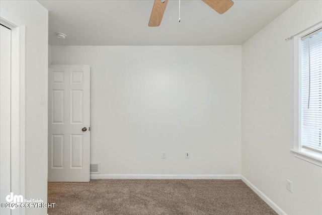 unfurnished room with ceiling fan and carpet floors