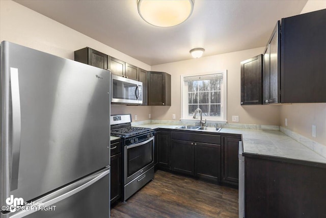 kitchen with dark hardwood / wood-style flooring, sink, dark brown cabinets, and stainless steel appliances