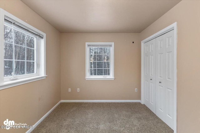 unfurnished bedroom featuring a closet and carpet