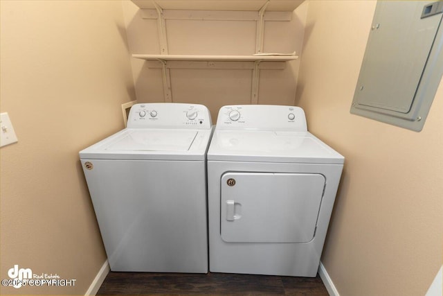 laundry room with dark wood-type flooring, electric panel, and washer and dryer