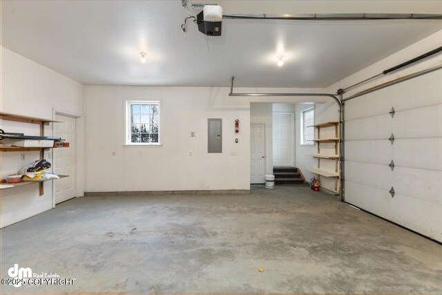 garage with a garage door opener and electric panel