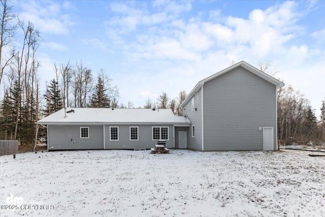 view of snow covered back of property