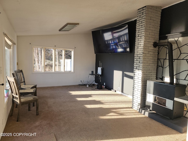 carpeted living room with vaulted ceiling