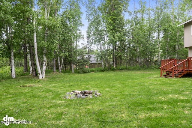 view of yard with a fire pit and a wooden deck