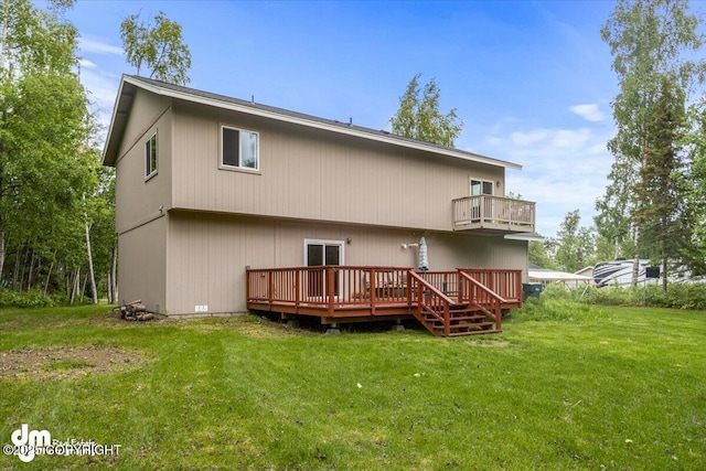 rear view of house with a deck, a yard, and a balcony