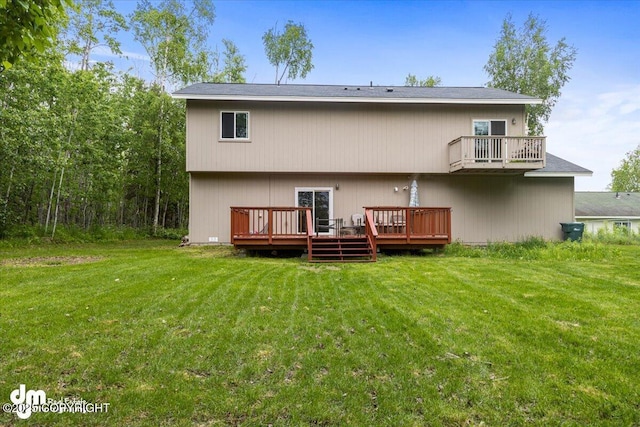 rear view of house with a lawn and a deck