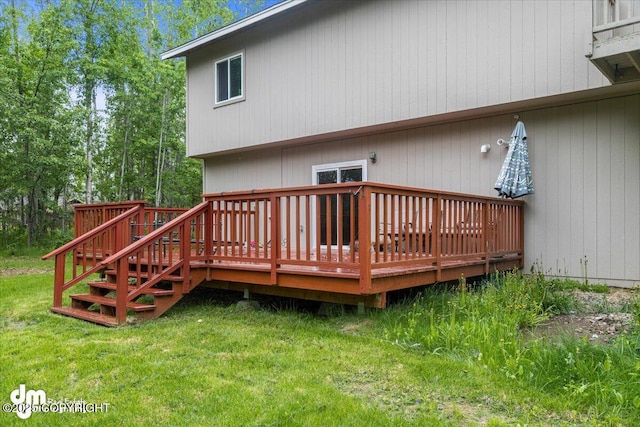 back of house with a lawn and a wooden deck