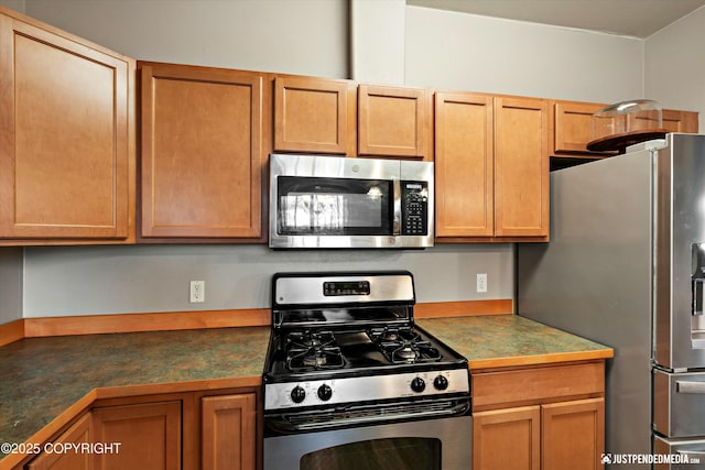 kitchen featuring appliances with stainless steel finishes and dark countertops