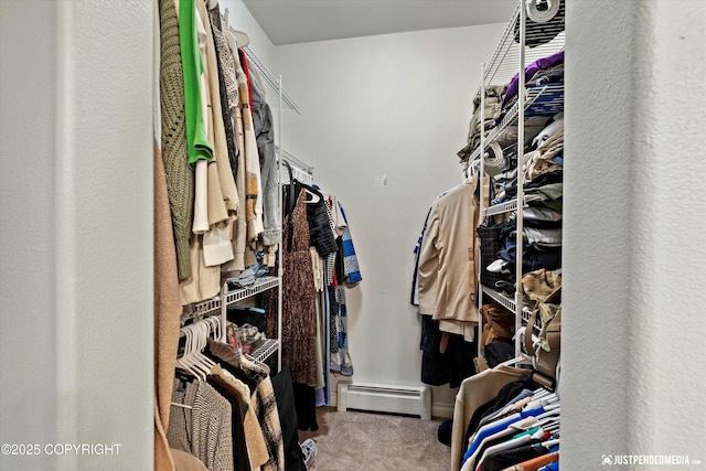 spacious closet with baseboard heating and carpet flooring