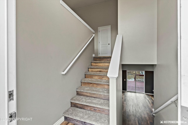 stairs featuring wood finished floors