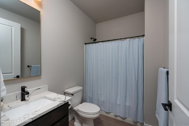 full bathroom featuring vanity, shower / tub combo, wood-type flooring, and toilet