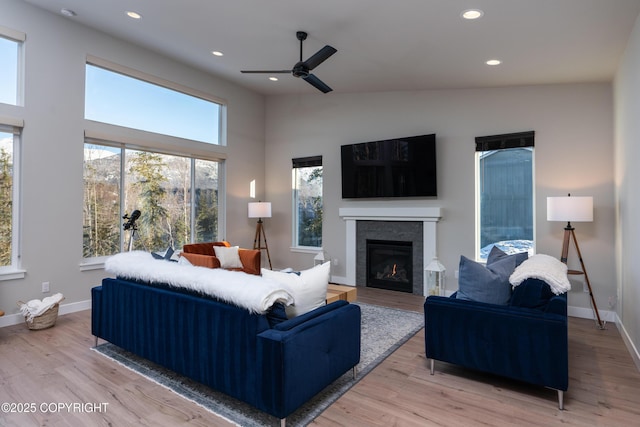 living room featuring ceiling fan and light hardwood / wood-style flooring