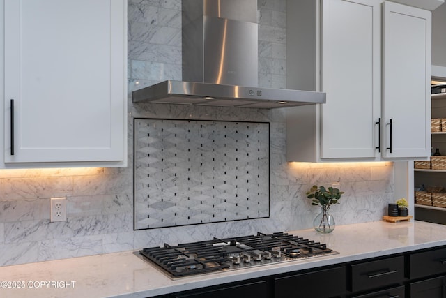 kitchen with white cabinets, backsplash, and wall chimney exhaust hood